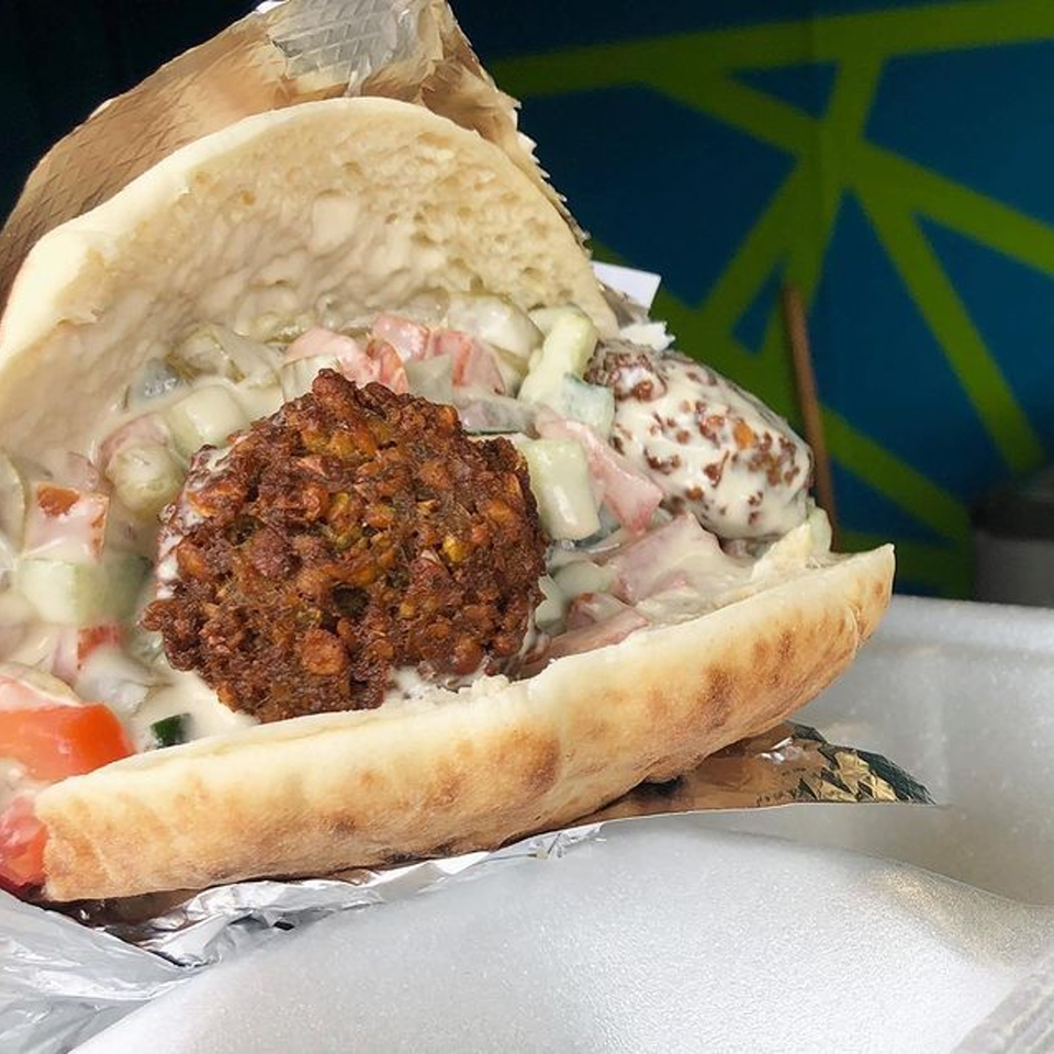 A Mordy's Corner falafel pita, filled with crispy falafel, salad, and creamy sauce.